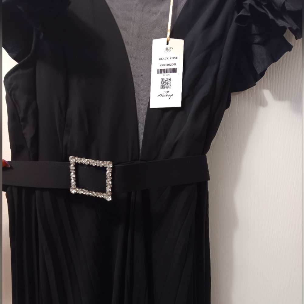 A  new black jumpsuit with a belt from Turkey.